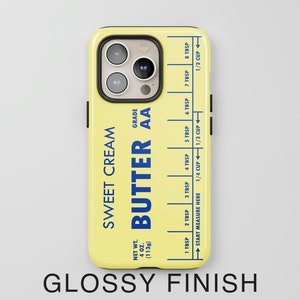 May include: A yellow phone case with a butter stick design. The case has a blue label that reads "Sweet Cream Butter AA" and includes a measurement guide in tablespoons and cups. The case has a glossy finish.