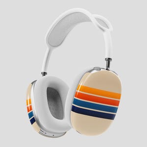 May include: White over-ear headphones with a cream-colored ear cup featuring horizontal stripes in orange, red, blue, and navy. The headband is white with a soft, padded interior. The earcups have a mesh interior.