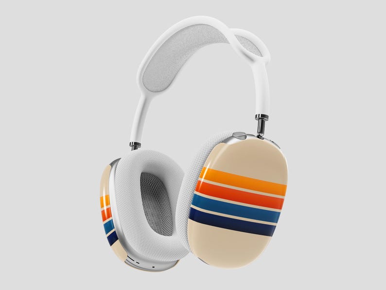 May include: White over-ear headphones with a cream-colored ear cup featuring horizontal stripes in orange, red, blue, and navy. The headband is white with a soft, padded interior. The earcups have a mesh interior.