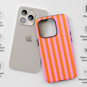 May include: A pink and orange striped phone case with a black border. The case is designed to protect a phone from impact and scratches. It is compatible with wireless charging.
