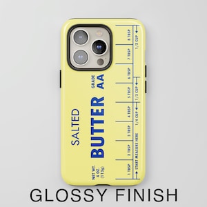 May include: A yellow iPhone case with a butter stick design. The case features the text "SALTED BUTTER AA GRADE" and a measurement guide in tablespoons and cups.