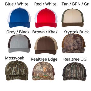 May include: Nine different baseball caps with various color combinations and patterns. The caps are arranged in three rows of three. The top row features a blue and white cap, a red and white cap, and a tan, brown, and green cap. The middle row features a gray and black cap, a brown and khaki cap, and a camouflage cap. The bottom row features a camouflage cap, a camouflage cap, and a camouflage cap.