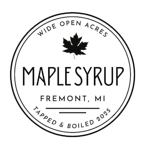 May include: A circular label with the words "WIDE OPEN ACRES" at the top and "MAPLE SYRUP" in large letters in the center. Below, it reads "FREMONT, MI" and "TAPPED & BOILED 2025". A black maple leaf is in the center.