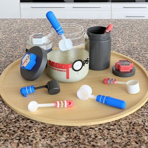 May include: A set of protein powder containers and scoops on a wooden tray. The containers are black and white with blue and red accents. The scoops are white with blue and red handles. The containers have the text "Muscle Ops" printed on them.