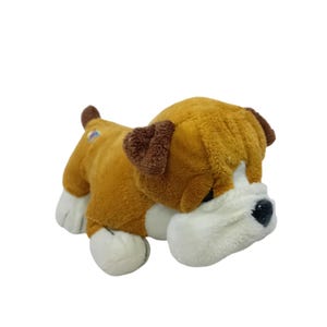 May include: A plush bulldog toy in shades of brown, tan, and white. The toy has a soft, textured body with brown ears and a white face. The bulldog has black eyes and a small, brown tail.
