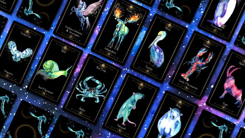 May include: A collection of tarot cards with watercolor illustrations of animals and celestial elements. Each card features a different animal, such as a snail, crab, and rat, with a corresponding word or phrase. The cards have a black background with gold borders.