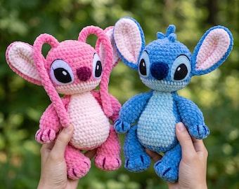 May include: Two plush crochet dolls featuring large ears and oval eyes. One doll is light and dark pink with a lighter pink belly, while the other is light and dark blue with a lighter blue belly. Both have round noses and textured yarn.