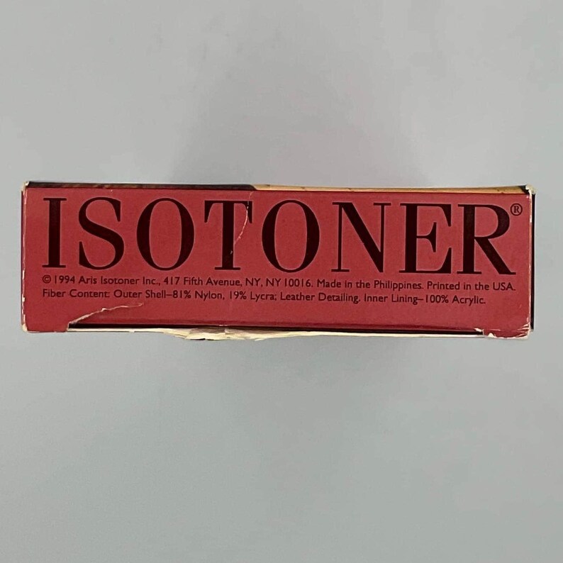 May include: A rectangular red product box with the brand name ISOTONER printed in large black capital letters. The box includes text detailing the 1994 copyright, address, manufacturing location, and fiber content of 81% nylon, 19% Lycra, and 100% acrylic.