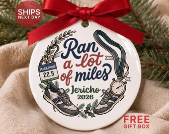 May include: A round white ceramic ornament with a red ribbon bow. The design features two running shoes, a marathon bib reading 22.5, a stopwatch, and the text "Ran a lot of miles" with the name "Jericho" and the year "2026" in dark green.