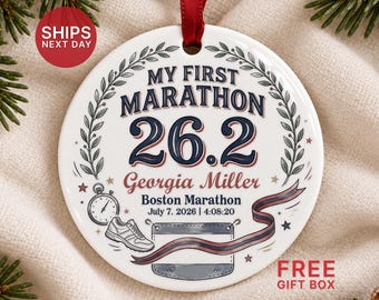 May include: A round white ceramic ornament with a red ribbon, featuring the text My First Marathon 26.2, Georgia Miller, Boston Marathon, and July 7, 2026, 4:08:20. It includes illustrations of a stopwatch, a running shoe, and a ribbon.