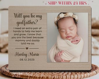 May include: A wooden picture frame with the text "Will you be my godfather?" and a photo of a baby. The frame includes the baby's name, Harley Marie, and the date 08.12.2025. The frame is light brown and has a natural wood grain.