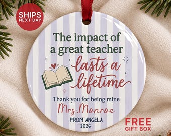 May include: A round ceramic ornament with a light purple and white striped background. It features the text: The impact of a great teacher lasts a lifetime. Thank you for being mine Mrs. Monroe FROM ANGELA 2026. An open book icon is included.