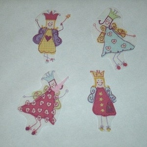 May include: Four colorful iron-on patches featuring fairies with wings and crowns. The fairies are wearing dresses with hearts and stars.