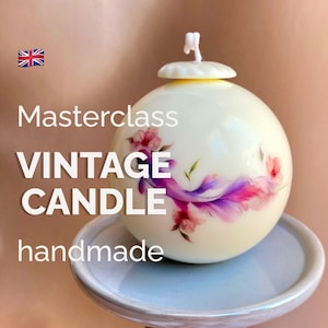 May include: A handmade vintage candle with a floral design in pink and purple hues. The spherical candle has a white top and rests on a light blue plate. The text "Masterclass VINTAGE CANDLE handmade" is visible.