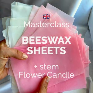 May include: A collection of pink and white beeswax sheets, with the text "Masterclass BEESWAX SHEETS + stem Flower Candle" and a small Union Jack flag. The sheets are held in a person's hands.