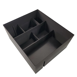 May include: Black plastic organizer with six compartments of varying sizes. The organizer is empty.