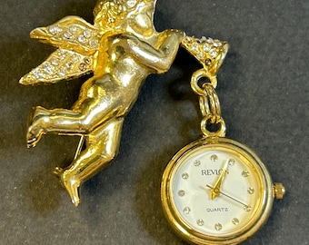 Womans Revlon Cherub brooch watch