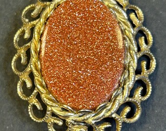 Vintage Goldstone cameo brooch