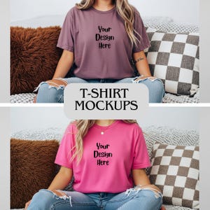 May include: T-shirt mockups featuring two short-sleeved shirts. One is a dusty rose color, the other is bright pink. Both shirts have the text "Your Design Here" printed on the front. The image also includes a brown pillow and a checkered pillow.