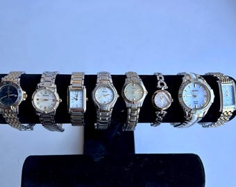 12 silver and gold two toned womens watches, sold separately