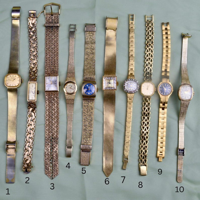 May include: A collection of ten vintage gold-toned wristwatches with various band styles. The watches feature different face shapes, including square, rectangular, and round. Some bands are mesh, while others have intricate link designs. The watches are displayed on a light green surface.
