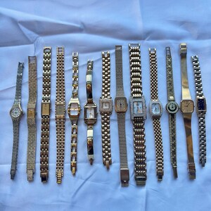 11 gold toned watches, sold separately