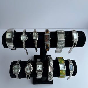 12 silver toned watches, sold separately