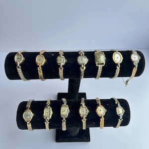 13 gold toned watches, sold separately