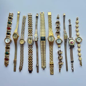 11 gold toned watches, sold separately