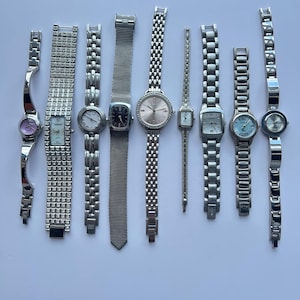 9 silver toned womens watches, sold separately