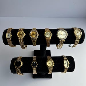 10 gold toned watches, sold separately