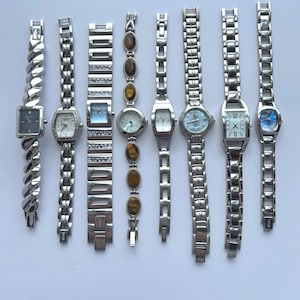8 silver toned womens watches, sold separately