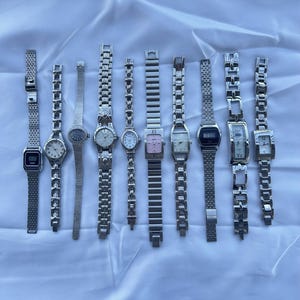10 silver and gold two toned watches, sold separately