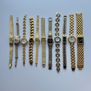 11 gold toned watches, sold separately