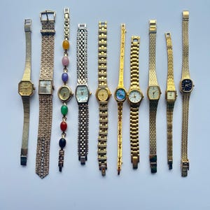 10 gold toned watches, sold separately