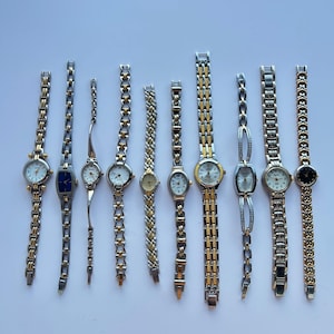 10 silver and gold two toned womens watches, sold separately