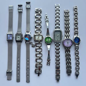 8 silver toned womens watches, sold separately