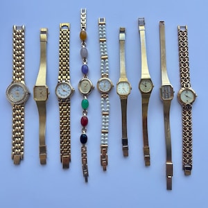 9 gold toned womens watches, sold separately