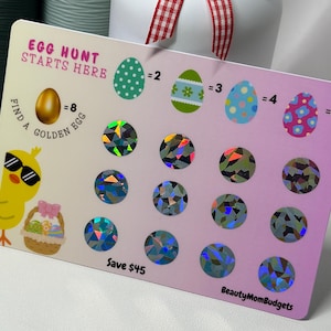 May include: Easter-themed card with the text "Egg Hunt Starts Here." Features a cartoon chick with sunglasses, decorated eggs, and holographic stickers. The card is designed to save $45.