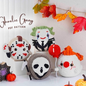 May include: A collection of handmade crochet Halloween characters, including a Jason Voorhees, a Joker, a Grim Reaper, and a clown holding a red balloon. The text "Ghoulie Gang PDF Pattern" is displayed above the characters. Decorative pumpkins and fall leaves are also present.