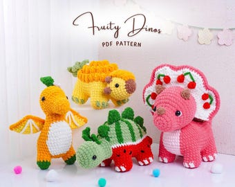 May include: A collection of four crocheted dinosaur toys in bright colors. One is orange with wings, two are yellow, one is green and red, and the last is pink with a white and red frill. The text "Fruity Dinos PDF PATTERN" is at the top.