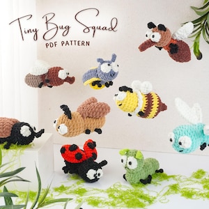 May include: A collection of handmade crochet bugs in various colors, including a ladybug, bee, and beetle. The text "Tiny Bug Squad PDF Pattern" is displayed at the top. The bugs are displayed on a white surface with green accents.