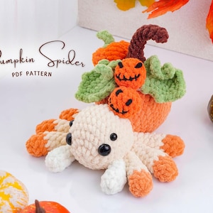 May include: A crocheted pumpkin spider with a cream-colored body and orange legs. The spider is next to a crocheted pumpkin with green leaves and two jack-o'-lantern faces. The text "Pumpkin Spider PDF Pattern" is in the image.