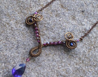 Bronze swirl necklace with garnets, Kashmir blue quartz and intricate wire weaving
