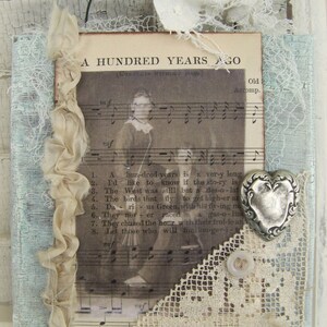 May include: A vintage sheet music page with a woman in a dress singing. The page is decorated with lace, a silver heart, and a button. The text on the page reads "A Hundred Years Ago (Complete Without Words)" and includes lyrics to a song.