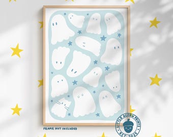 May include: A framed print featuring white ghost illustrations on a light blue background, interspersed with blue stars. The print includes the text "MORE COLOUR OPTIONS AVAILABLE" at the top and the text "FRAME NOT INCLUDED" at the bottom. The print is surrounded by yellow star stickers.