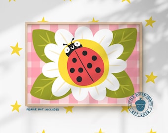 May include: A framed print featuring a cartoon ladybug on a daisy. The ladybug is red with black spots, set against a yellow center and white petals. The background is a pink gingham pattern. The text "FRAME NOT INCLUDED" is visible.