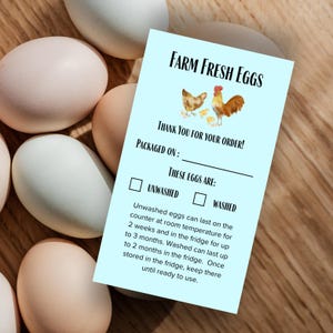 May include: A light blue card with the text "FARM FRESH EGGS" and a watercolor illustration of a hen, rooster, and chicks. The card also includes space to indicate if the eggs are washed or unwashed.
