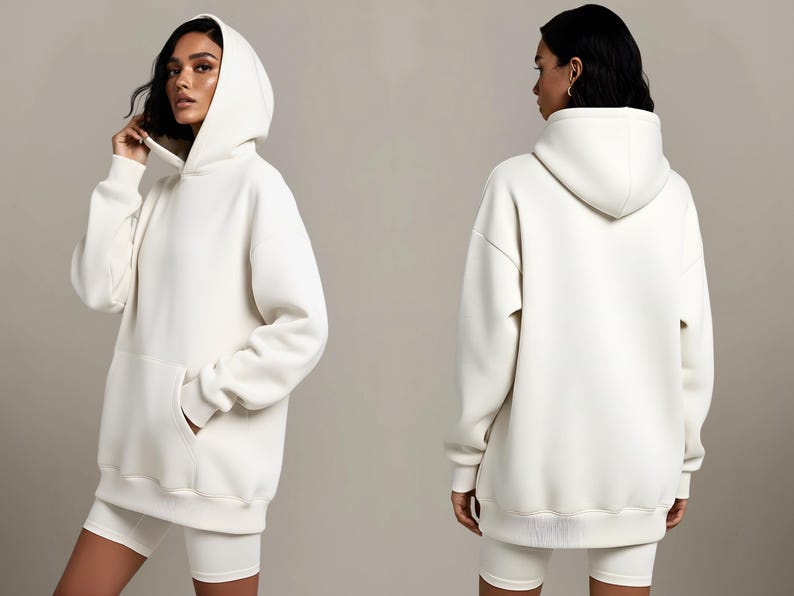 May include: Off-white hoodie with a front pocket and a matching pair of shorts. The hoodie has a drawstring hood and ribbed cuffs and hem. The model is wearing the hoodie and shorts. The outfit is made of a soft, comfortable material.