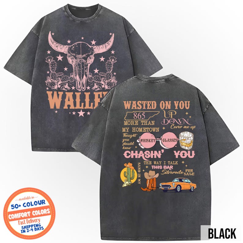May include: Black graphic t-shirt with a steer skull and cactus design on the front. The back of the shirt features text and illustrations including a cowboy hat, car, and whiskey glasses. The shirt is a comfort color.